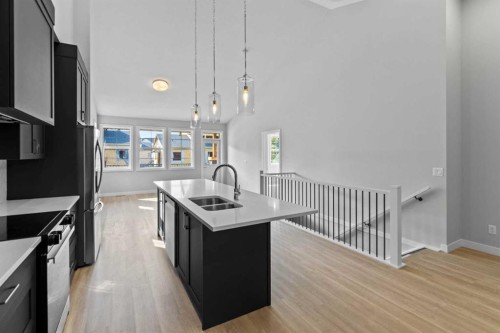 601-15 Coopersfield Link Sw, Airdrie, AB - Indoor Photo Showing Kitchen With Double Sink With Upgraded Kitchen