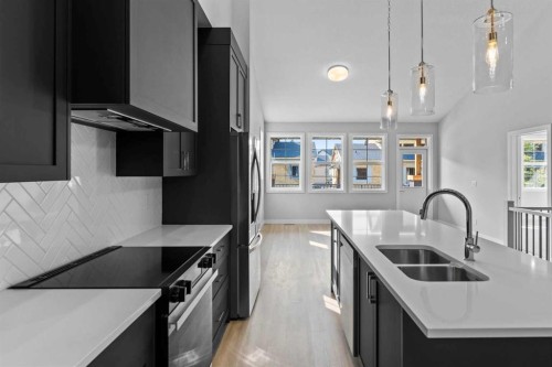 601-15 Coopersfield Link Sw, Airdrie, AB - Indoor Photo Showing Kitchen With Double Sink With Upgraded Kitchen
