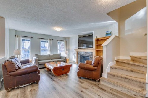 199 Everglen Way Sw, Calgary, AB - Indoor Photo Showing Living Room With Fireplace