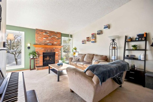 76 Bedford Circle Ne, Calgary, AB - Indoor Photo Showing Living Room With Fireplace