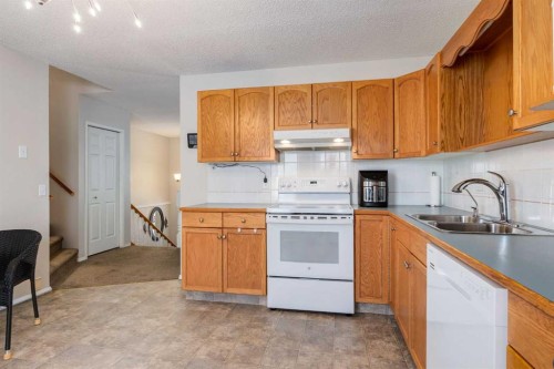 145 Fairway View Nw, High River, AB - Indoor Photo Showing Kitchen With Double Sink