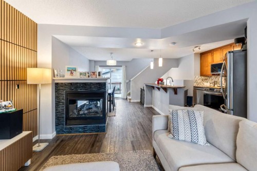 243 New Brighton Landing Se, Calgary, AB - Indoor Photo Showing Living Room With Fireplace