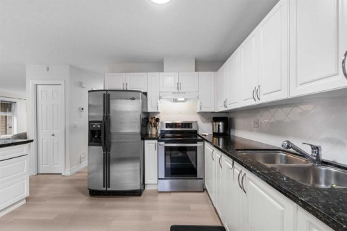 27 Cedarwood Lane Sw, Calgary, AB - Indoor Photo Showing Kitchen With Stainless Steel Kitchen With Double Sink