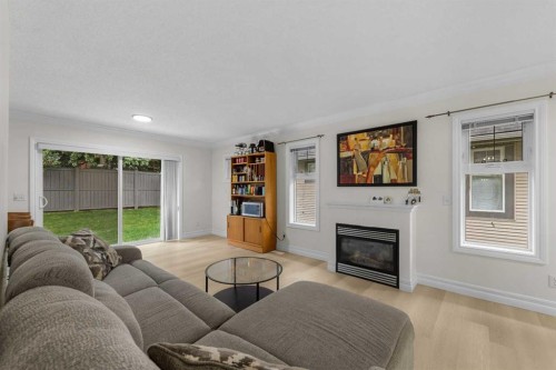 27 Cedarwood Lane Sw, Calgary, AB - Indoor Photo Showing Living Room With Fireplace