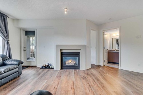 113-35 Richard Court Sw, Calgary, AB - Indoor Photo Showing Living Room With Fireplace