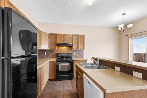 1083 Prairie Springs Hill Sw, Airdrie, AB - Indoor Photo Showing Kitchen With Double Sink