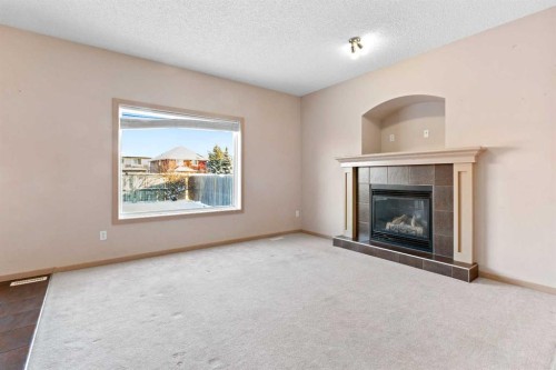 1083 Prairie Springs Hill Sw, Airdrie, AB - Indoor Photo Showing Living Room With Fireplace