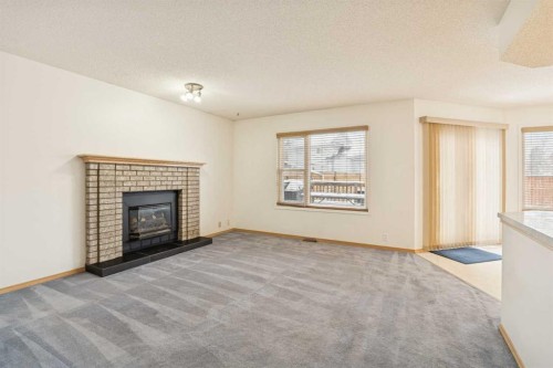 2498 Catalina Boulevard Ne, Calgary, AB - Indoor Photo Showing Living Room With Fireplace