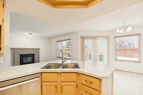 2498 Catalina Boulevard Ne, Calgary, AB - Indoor Photo Showing Kitchen With Fireplace