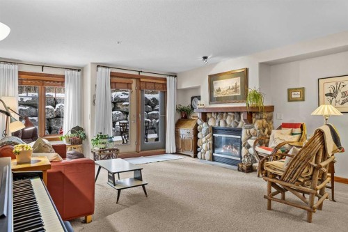 112-150 Crosbow Place, Canmore, AB - Indoor Photo Showing Living Room With Fireplace