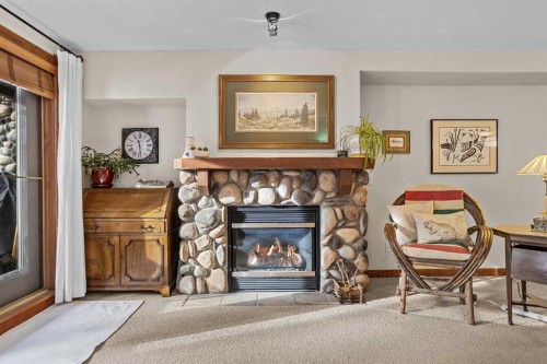 112-150 Crosbow Place, Canmore, AB - Indoor Photo Showing Living Room With Fireplace