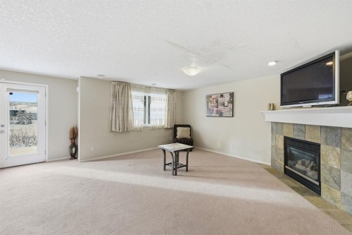 124 Evansbrooke Landing Nw, Calgary, AB - Indoor Photo Showing Living Room With Fireplace