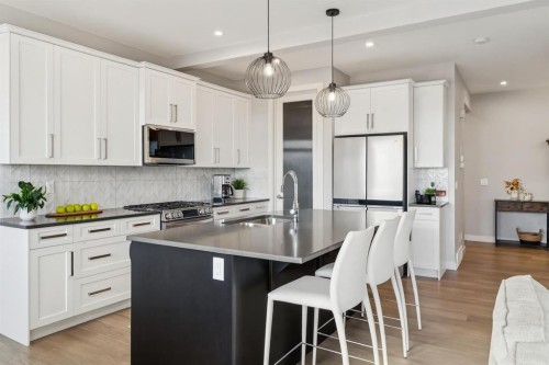 363 Precedence Hill, Cochrane, AB - Indoor Photo Showing Kitchen With Stainless Steel Kitchen With Upgraded Kitchen