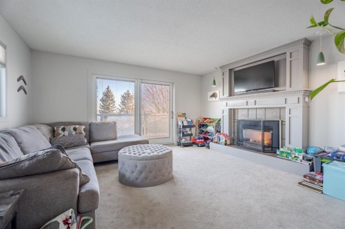 84 Thornaby Crescent Nw, Calgary, AB - Indoor Photo Showing Living Room With Fireplace