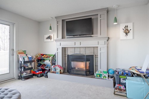 84 Thornaby Crescent Nw, Calgary, AB - Indoor Photo Showing Living Room With Fireplace