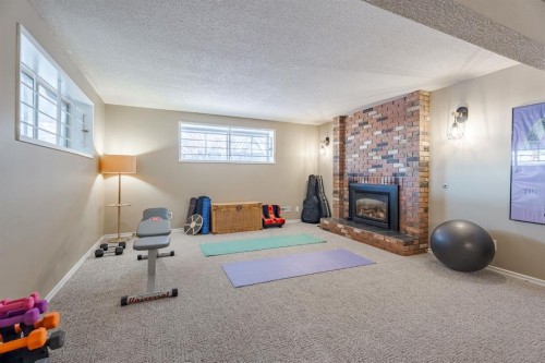84 Thornaby Crescent Nw, Calgary, AB - Indoor With Fireplace