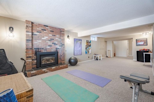 84 Thornaby Crescent Nw, Calgary, AB - Indoor Photo Showing Other Room With Fireplace
