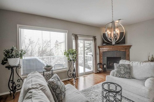 96 Hampstead Green Nw, Calgary, AB - Indoor Photo Showing Living Room With Fireplace