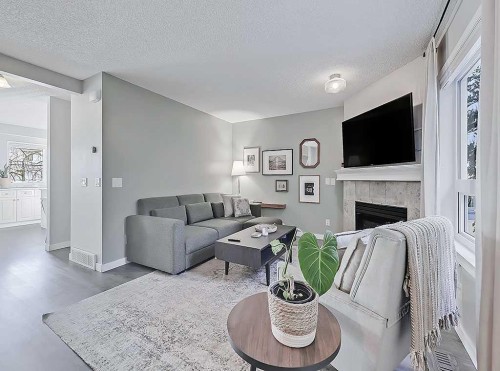 3-119 23 Avenue Ne, Calgary, AB - Indoor Photo Showing Living Room With Fireplace