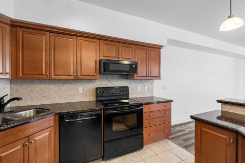 108-11642 Valley Ridge Park Nw, Calgary, AB - Indoor Photo Showing Kitchen With Double Sink