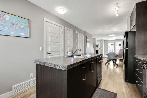 220 Mckenzie Towne Close Se, Calgary, AB - Indoor Photo Showing Kitchen With Double Sink