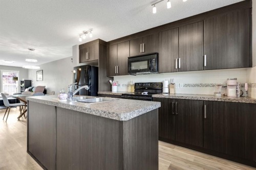 220 Mckenzie Towne Close Se, Calgary, AB - Indoor Photo Showing Kitchen With Double Sink