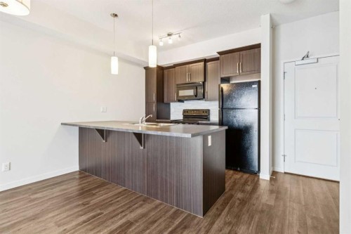 9312-101 Sunset Drive, Cochrane, AB - Indoor Photo Showing Kitchen With Double Sink