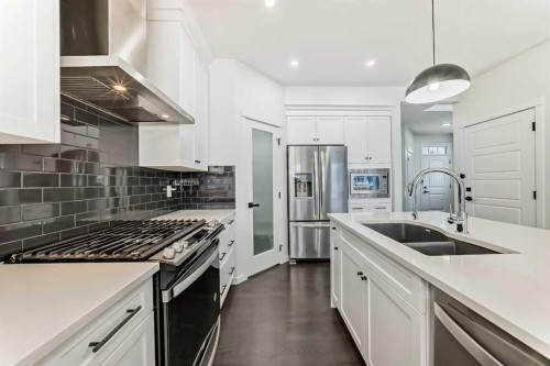 31 Creekside Grove Sw, Calgary, AB - Indoor Photo Showing Kitchen With Stainless Steel Kitchen With Double Sink With Upgraded Kitchen