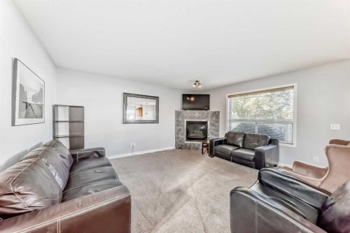 307 Panatella Court Nw, Calgary, AB - Indoor Photo Showing Living Room With Fireplace