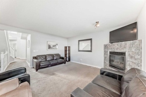 307 Panatella Court Nw, Calgary, AB - Indoor Photo Showing Living Room With Fireplace