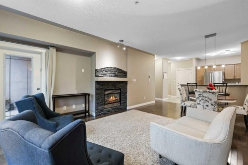 313-20 Discovery Ridge Close Sw, Calgary, AB - Indoor Photo Showing Living Room With Fireplace