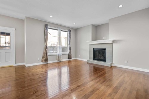 24 Panatella Square Nw, Calgary, AB - Indoor Photo Showing Living Room With Fireplace