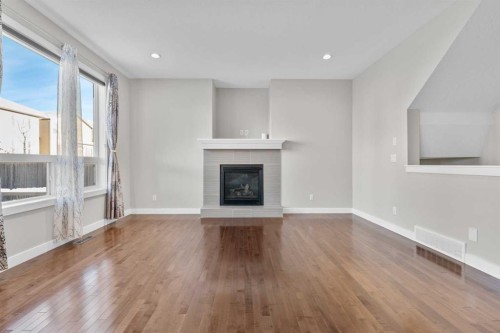 24 Panatella Square Nw, Calgary, AB - Indoor Photo Showing Living Room With Fireplace