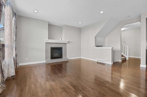 24 Panatella Square Nw, Calgary, AB - Indoor Photo Showing Living Room With Fireplace