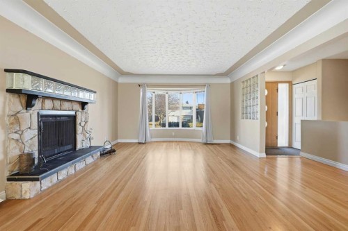2219 Halifax Crescent Nw, Calgary, AB - Indoor Photo Showing Living Room With Fireplace