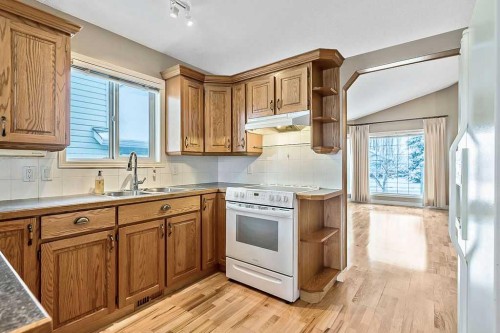 13 Sheep River Link, Okotoks, AB - Indoor Photo Showing Kitchen With Double Sink