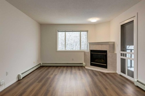 310-30 Sierra Morena Mews Sw, Calgary, AB - Indoor Photo Showing Living Room With Fireplace