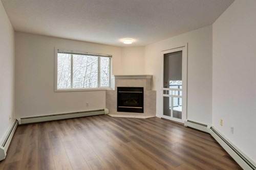 310-30 Sierra Morena Mews Sw, Calgary, AB - Indoor Photo Showing Living Room With Fireplace