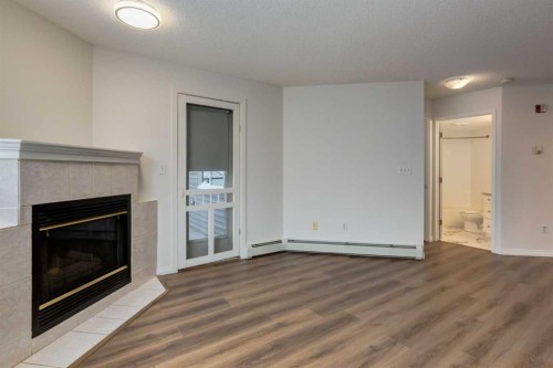310-30 Sierra Morena Mews Sw, Calgary, AB - Indoor Photo Showing Living Room With Fireplace