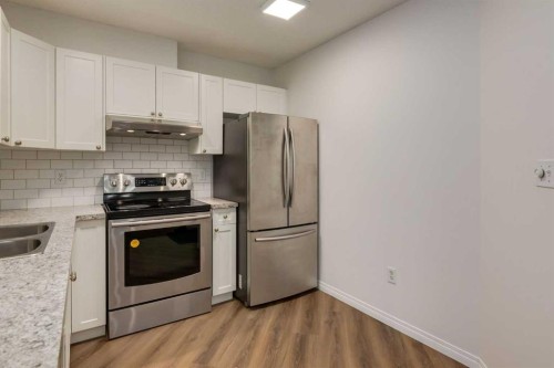 310-30 Sierra Morena Mews Sw, Calgary, AB - Indoor Photo Showing Kitchen With Stainless Steel Kitchen With Double Sink