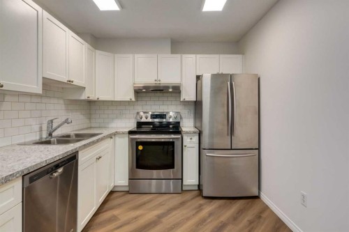310-30 Sierra Morena Mews Sw, Calgary, AB - Indoor Photo Showing Kitchen With Stainless Steel Kitchen With Double Sink