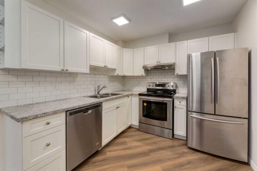 310-30 Sierra Morena Mews Sw, Calgary, AB - Indoor Photo Showing Kitchen With Stainless Steel Kitchen With Double Sink