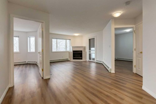 310-30 Sierra Morena Mews Sw, Calgary, AB - Indoor Photo Showing Other Room With Fireplace