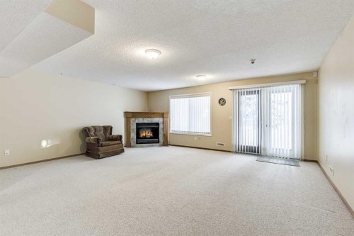 19 Signature Villas Sw, Calgary, AB - Indoor With Fireplace