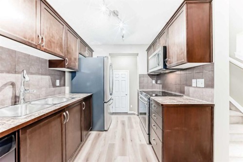 3019 Windsong Boulevard Sw, Airdrie, AB - Indoor Photo Showing Kitchen With Double Sink