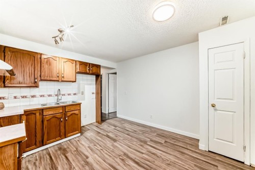 34 Erin Meadow Close Se, Calgary, AB - Indoor Photo Showing Kitchen With Double Sink