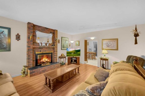 11 Berwick Close Nw, Calgary, AB - Indoor Photo Showing Living Room With Fireplace