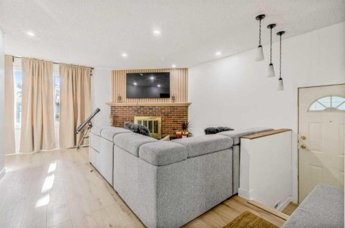 147 Dovercliffe Way Se, Calgary, AB - Indoor Photo Showing Other Room With Fireplace