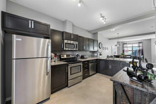 68 New Brighton Point Se, Calgary, AB - Indoor Photo Showing Kitchen With Stainless Steel Kitchen With Double Sink With Upgraded Kitchen