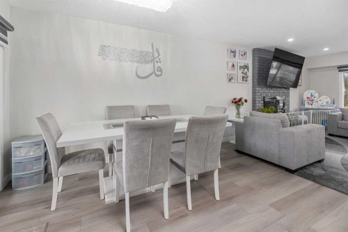 255 Rundleridge Drive Ne, Calgary, AB - Indoor Photo Showing Dining Room With Fireplace